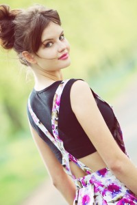 Cropped top worn with floral print pinafore