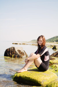 UK teen blogger sitting on rock at Muasdale Beach Argyll Scotland
