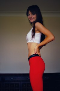 Smiling blogger wearing red Nike Pro leggings