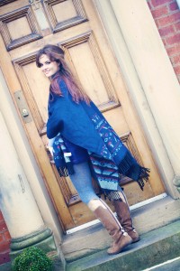 teen wearing shawl scard in front of door