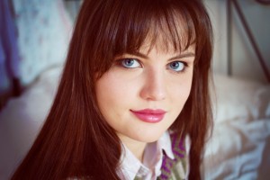 Teen blogger with straight brunette hair and blue eyes