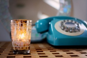 Vintage style telephone and patterned glass candle holder