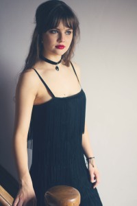 Brunette teen blogger wearing fringed Great Gatsby style dress