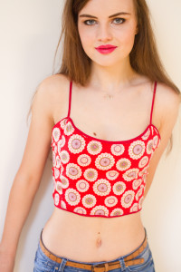 Smiling blogger wearing red print cropped top