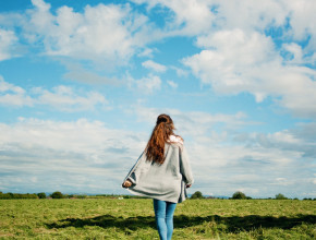 Teen blogger photographed against blue sky