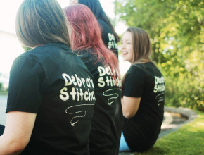 Group of girls wearing black printed t-shirts