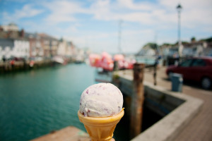 Ice cream cone with harbour scene in background