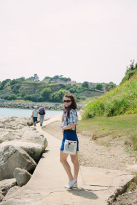 Teen girl walking along seaside path in Weymouth UK.