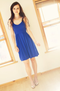Tall teenage girl wearing strappy blue dress