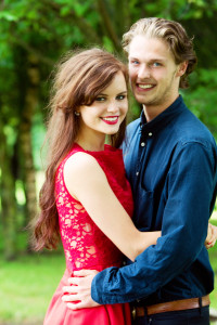 Young couple hugging. girl wears red dress from Jones & Jones London