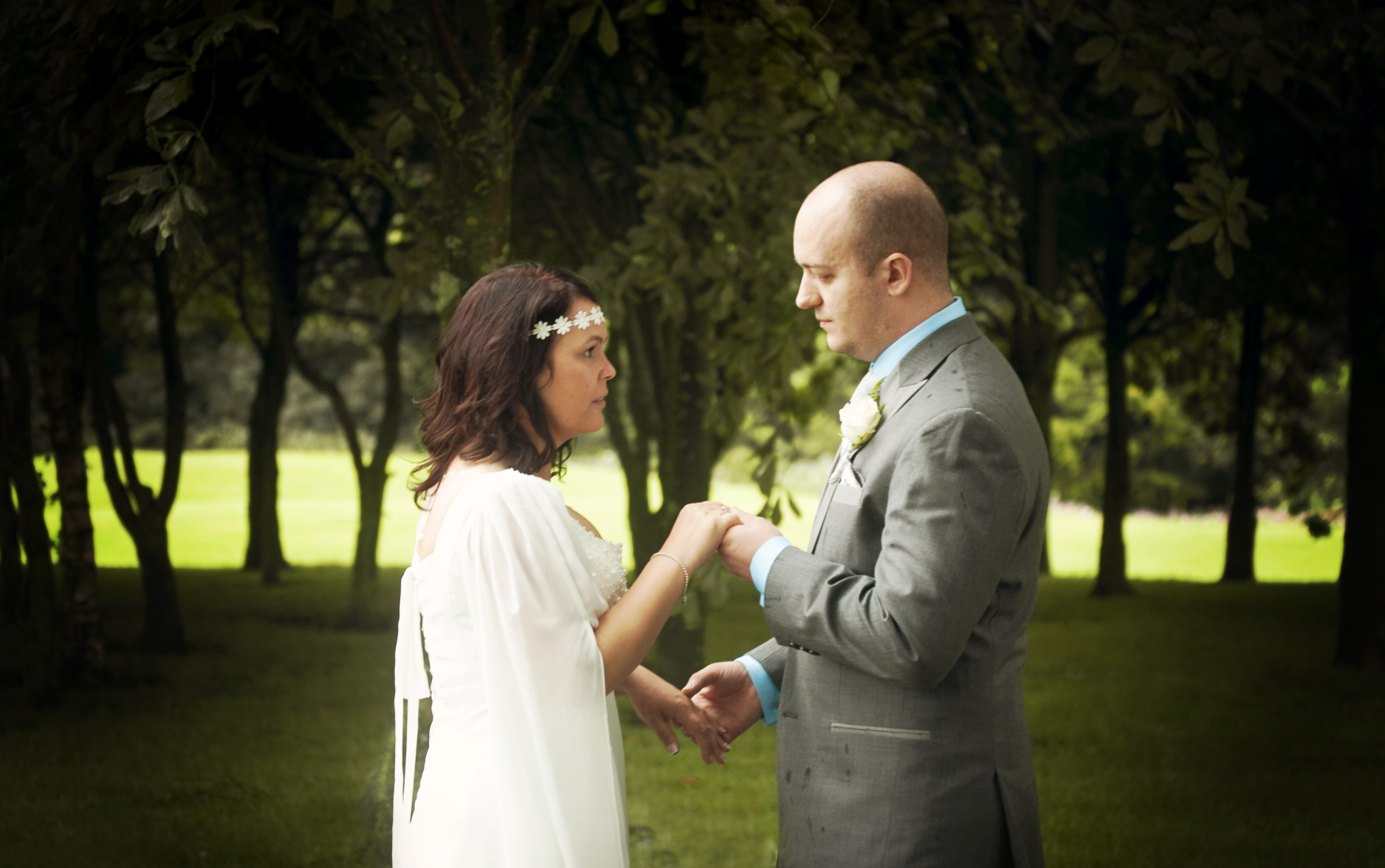Wedding photography. Bride wearing medieval style dress holding hands with groom