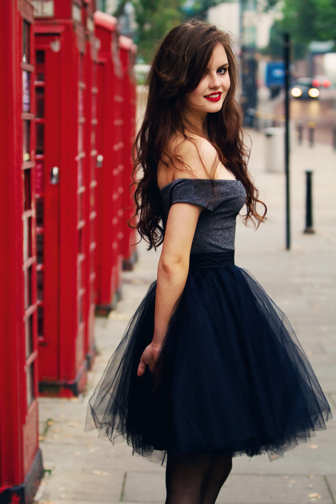 brunette-stood-in-front-of-phone-boxes
