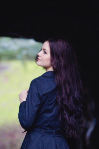 Teen girl with pale skin and long wavy dark hair