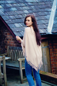 Beige poncho and jeans outfit