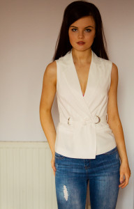 Brunete teen girl wearing ripped jeans and wrapover white shirt
