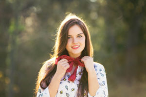 Teen wearing white shirt and bandana scarf
