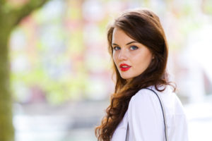 Brunette teen with blue eyes and red lipstick