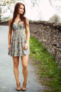 Teen girl with long brunette hair wearing Top Shop dress