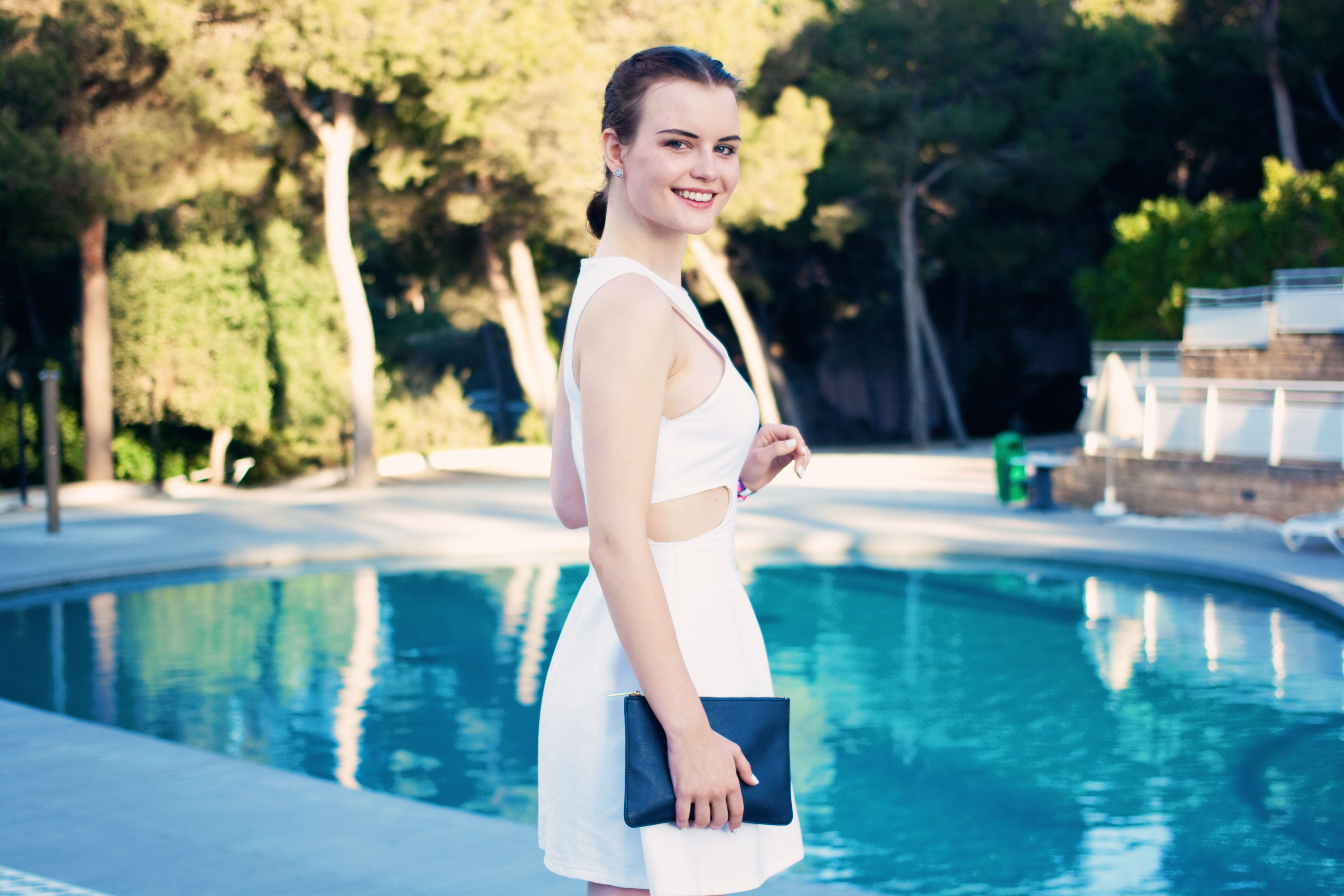 Teen girl portrait by pool. Glam summer outfit