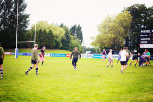 Men playing rugby in dresses!