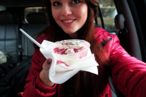 Girl holding pot of porridge and berries