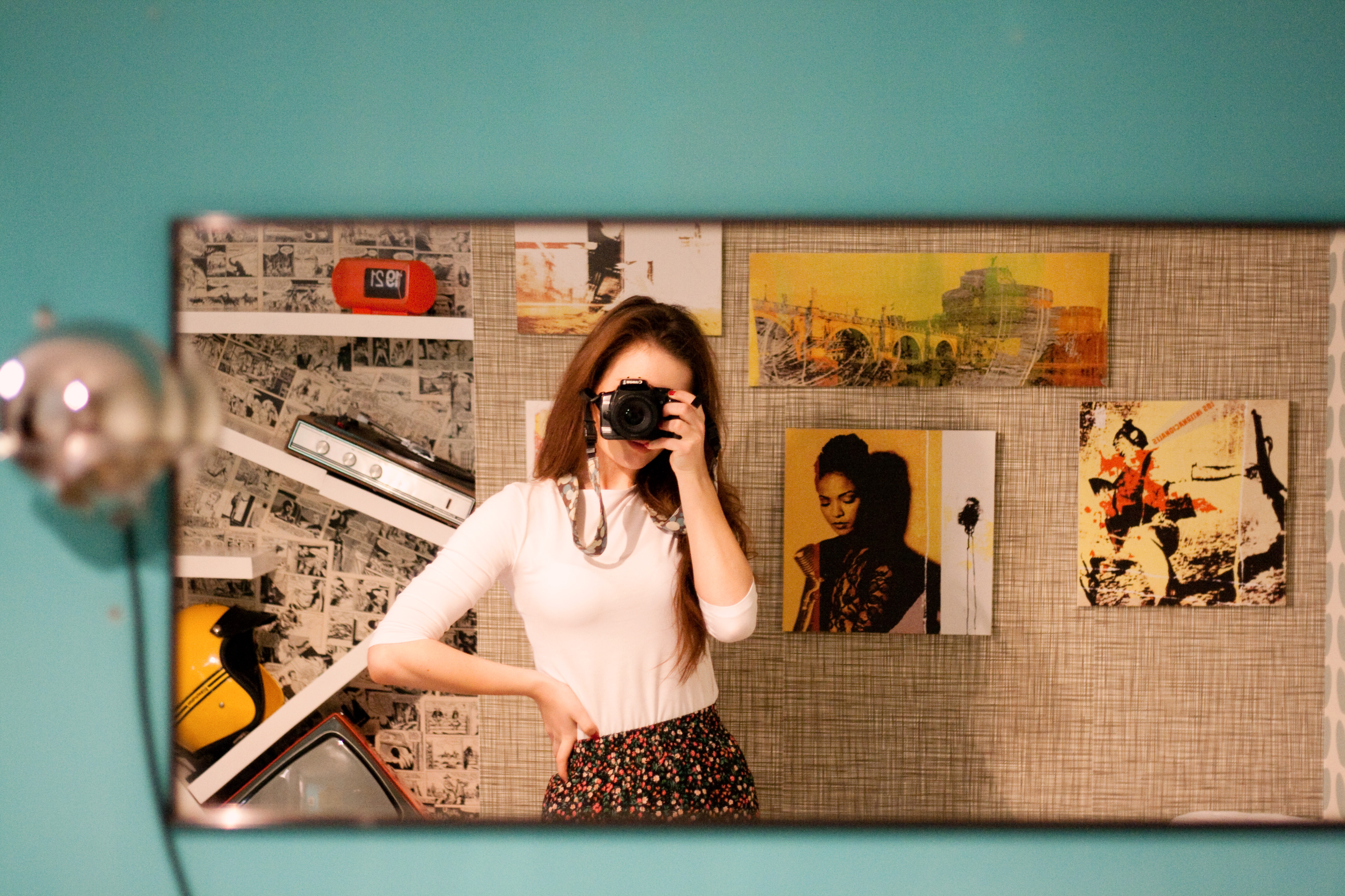 Girl's reflection in front of wide rectangle mirror. Retro style hotel in Rome Italy.