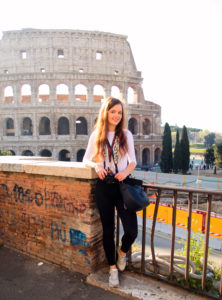 Female tourist photographer at Colosseum rome