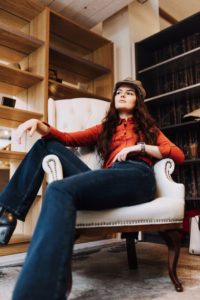 Female model lounging in white leather chair