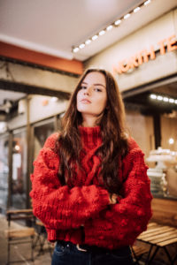 Girl wearing red chunky knitted cable sweater