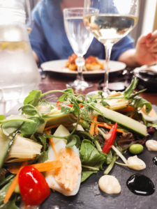 Artichoke salad with glass of white wine