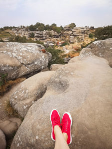 Feet wearing red trainers at Brimham Rocks Yorkshire