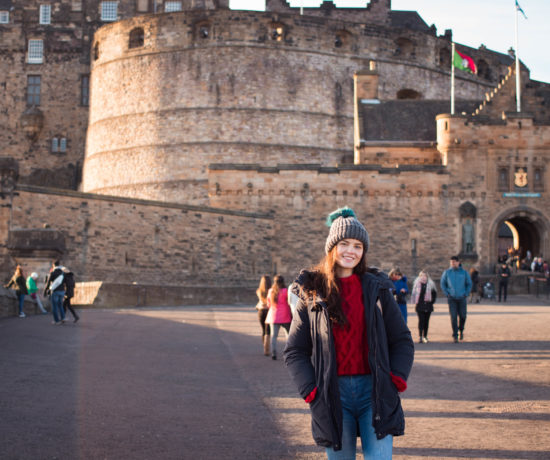 Young woman standing in front of Edinburgh Castle